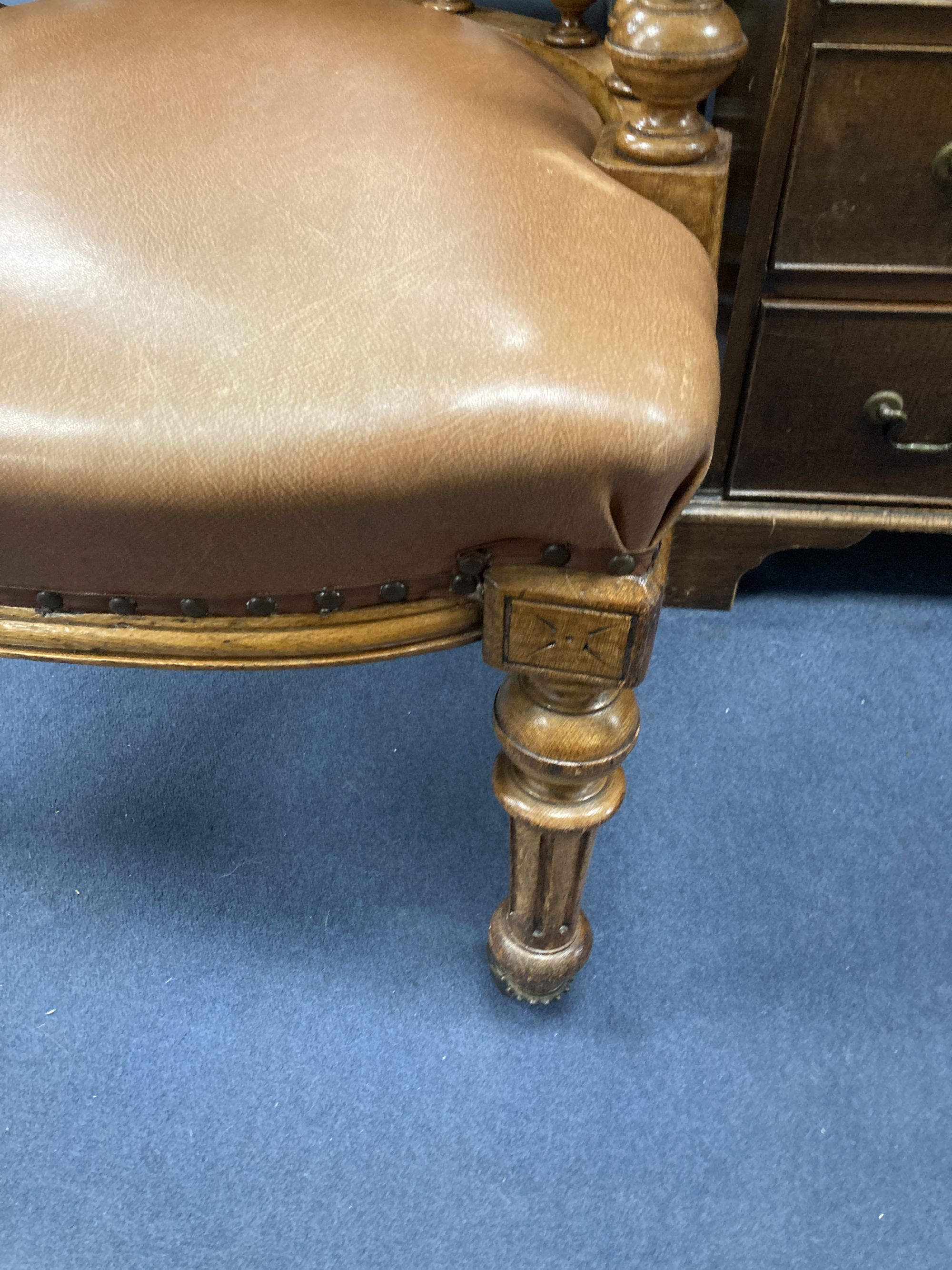 A Victorian oak tub framed library chair, upholstered in brown leather, width 60cm, depth 60cm, height 74cm